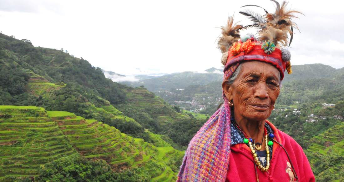 Banaue rice terraces in the Philippines Tribe woman standing in front of the banaue rice terraces in the Philippines