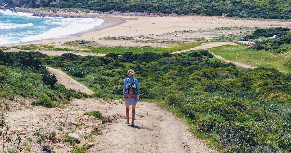 Remote Beach A traveler walks down to an empty beach
