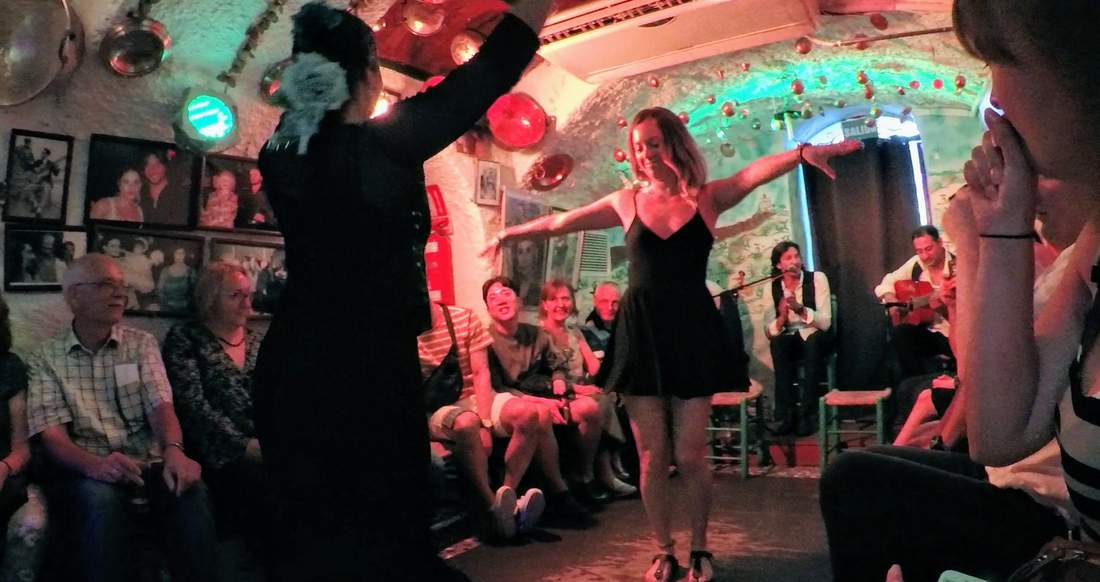 Flamenco Spain A girl gets Flamenco lessons in a small room surrounded by people