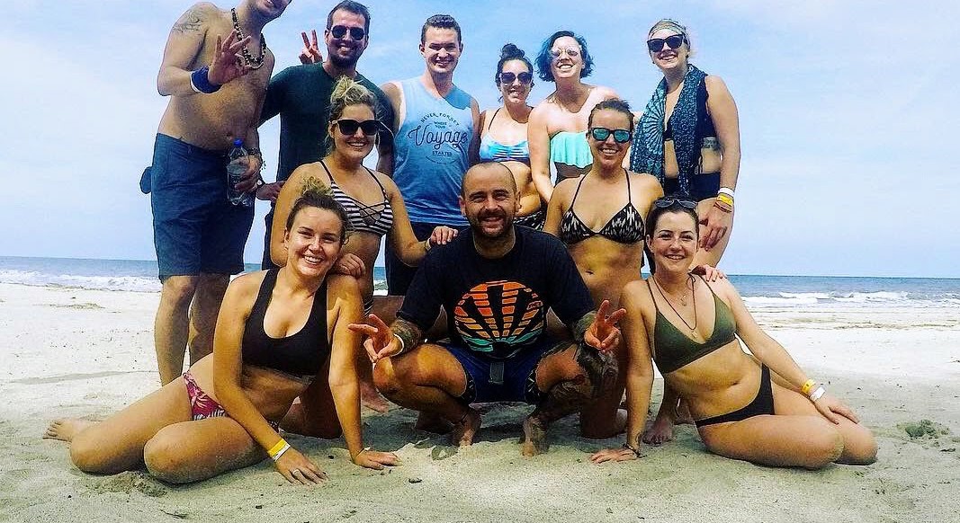 Beach Group Shot A group of travelers poses on a beach in Colombia