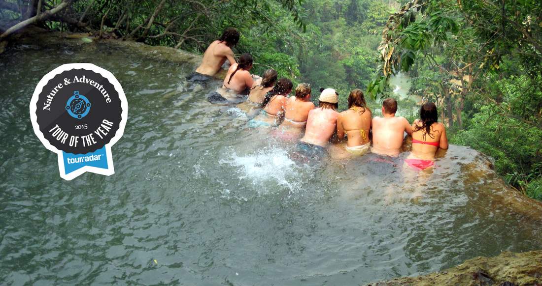 Travelers in Kuang Si Falls in Laos Travelers in the pool of a Kuang Si waterfalls in Luang Prabang Laos