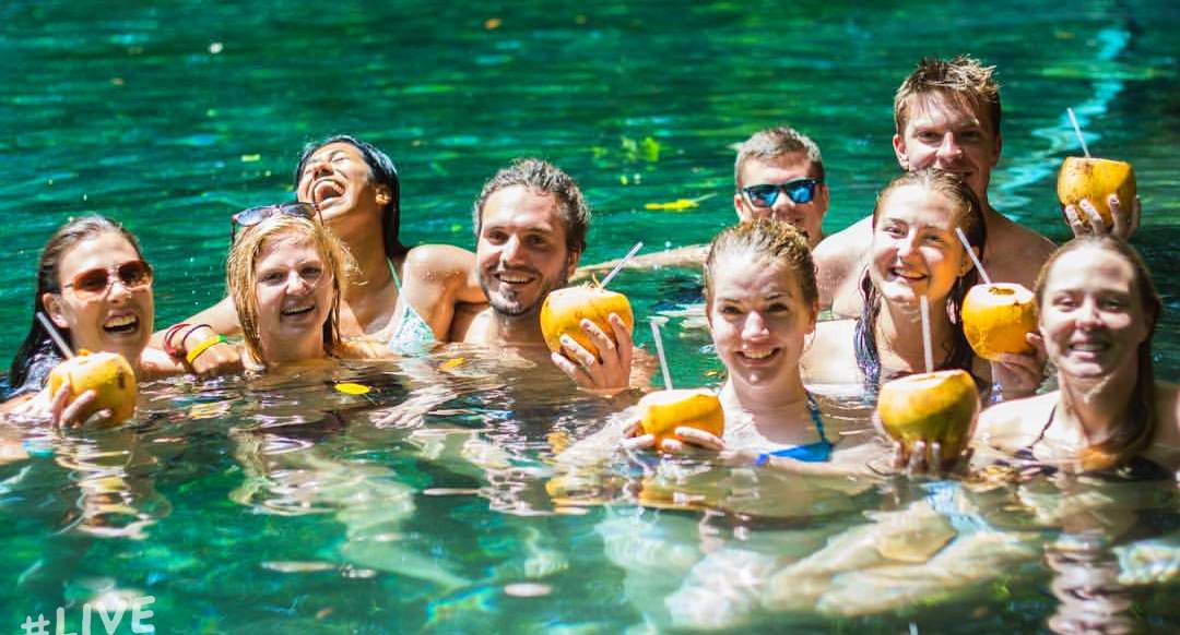 Ometepe Nicaragua A group of people swimming in a lagoon drink from Coconuts