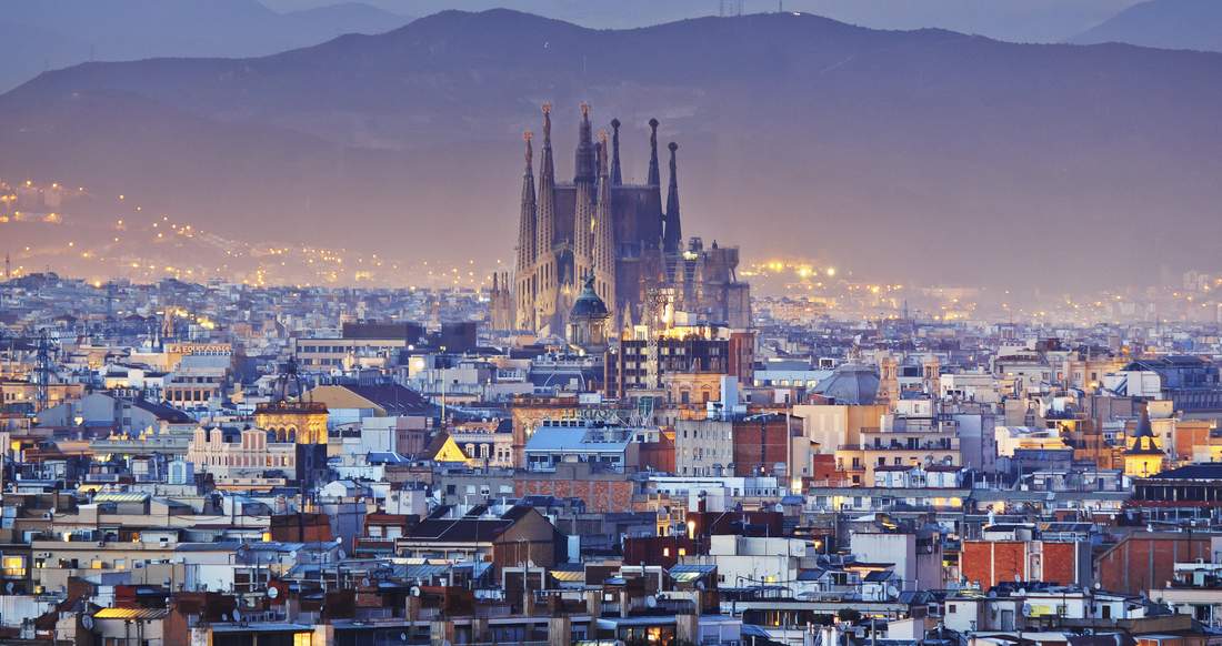 Sagrada Familia Barcelona Sagrada Familia towering over the expansive city of Barcelona at dusk