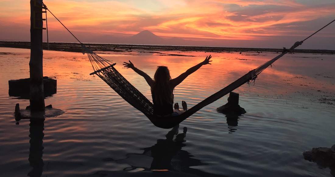 Sunset Hammock Indonesia Girl watching beautiful sunset from a hammock in Indonesia
