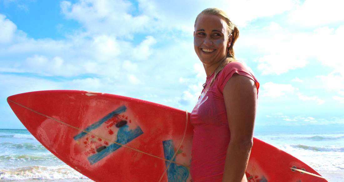 Surfing Costa Rica Close up of a girl smiling and holding a surfboard