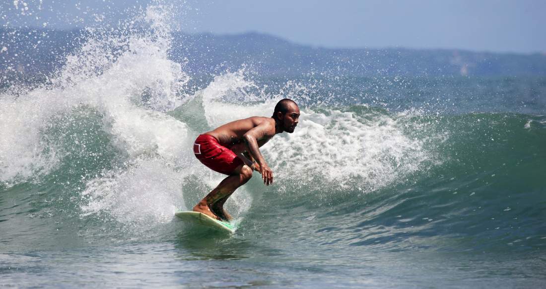 Surfing Indonesia Man surfing in Indonesia on big blue waves