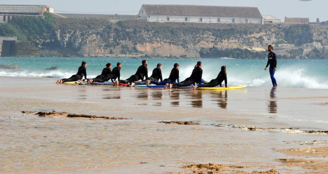 Surfing Tarifa Spain A group of people get surf lessons on brightly coloured surf boards