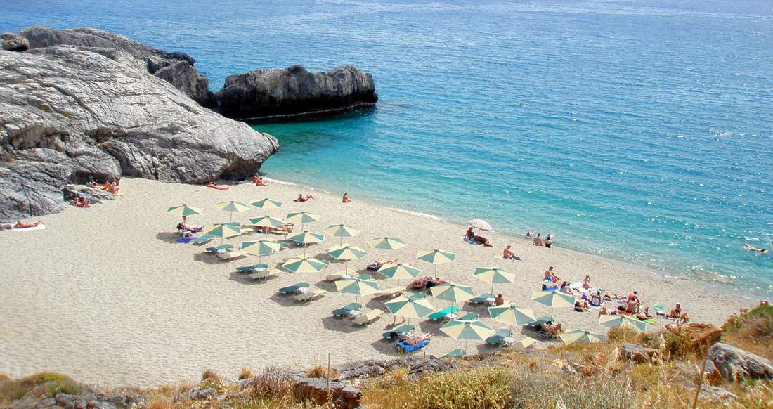 Greek beach secluded beach with umbrellas in the Greek Islands
