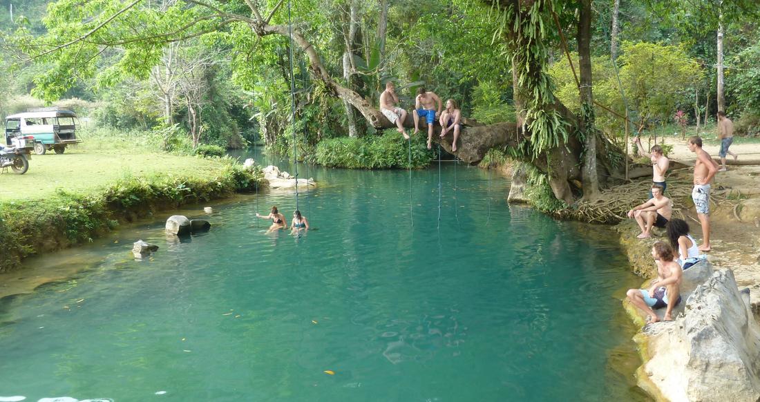 Blue Lagoon in Laos People hanging out around a river in Laos