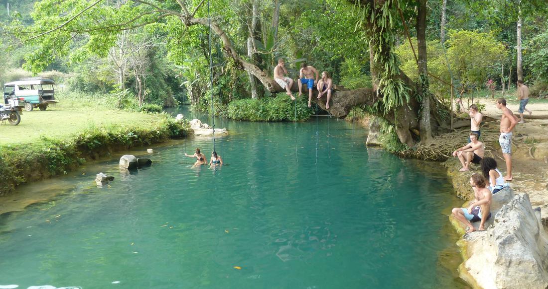 Blue Lagoon in Laos People hanging out around a river in Laos