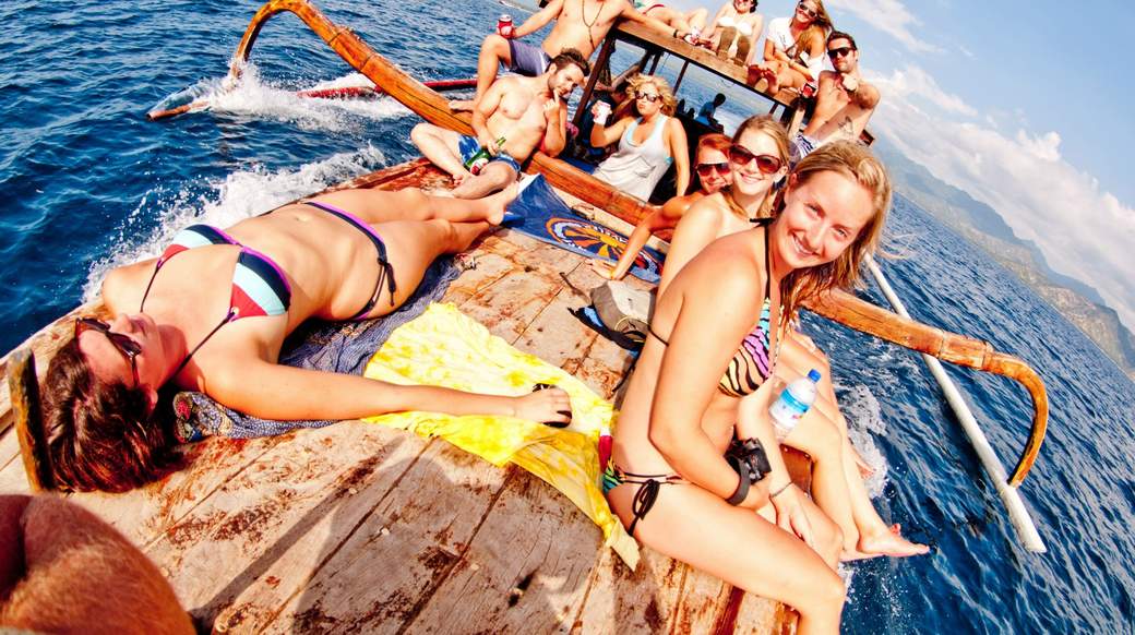 Indonesia Boat Ride Group of girls on a boat enjoying the sun in Indonesia