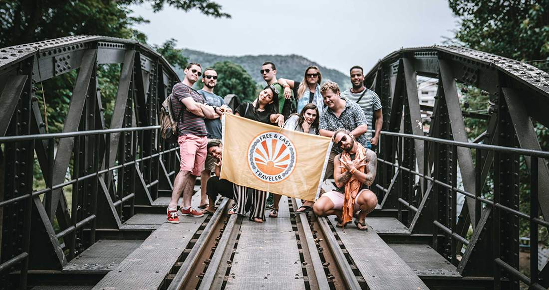 Travelers on a bridge in Thailand group shot on a bridge over river Kwai Thailand