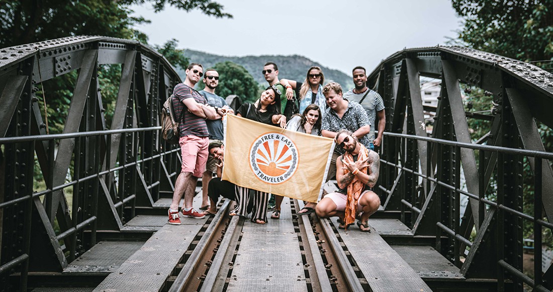 Travelers on a bridge in Thailand group shot on a bridge over river Kwai Thailand
