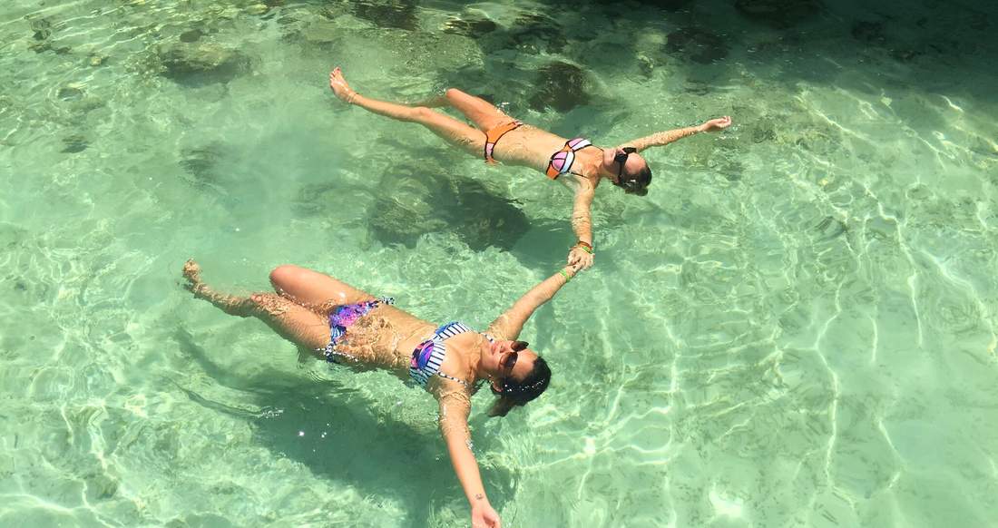 Clear ocean in the Philippines Two girls floating in clear ocean water in the Philippines