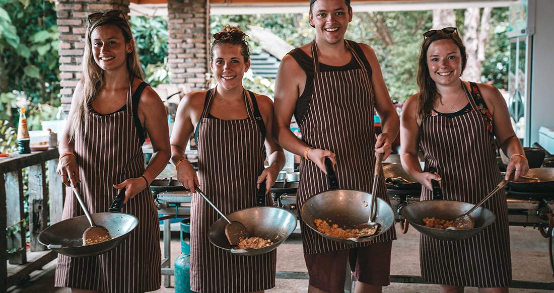 Cooking class in Southern Thailand Travelers cooking Thai food at a cooking class in Thailand