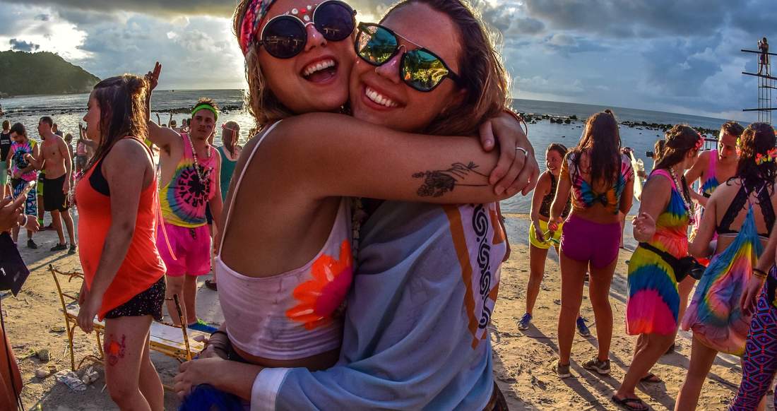 Girls at Full Moon Party in Thailand Two girls hugging on a beach at Full Moon Party in Thailand