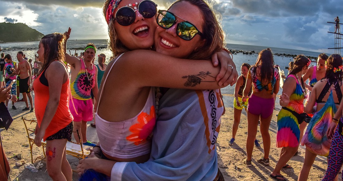 Girls at Full Moon Party in Thailand Two girls hugging on a beach at Full Moon Party in Thailand