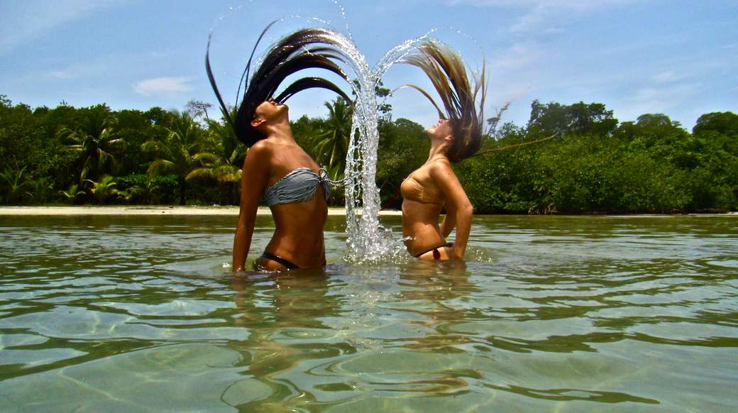 hair flip girls flipping their hair in the ocean in panama