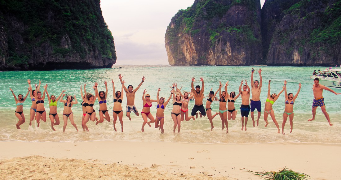 Maya Bay Group of travelers jumping up on Maya Bay beach in southern Thailand