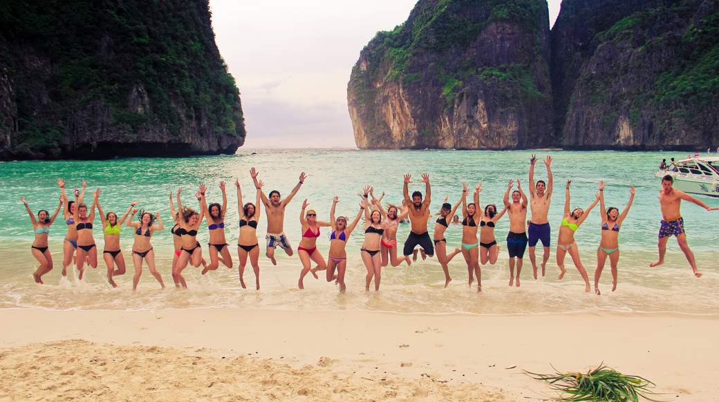 maya bay beach Group of travelers jumping up on May Beach in Southern Thailand