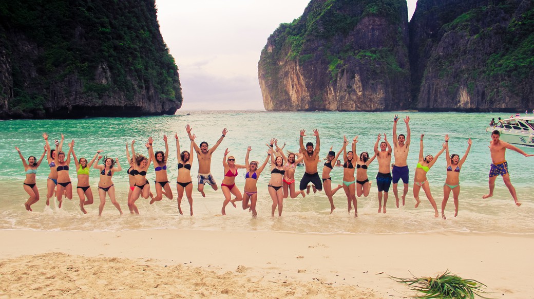 maya bay beach Group of travelers jumping up on May Beach in Southern Thailand