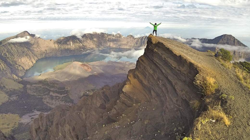 Mount Rinjani A traveler enjoying an view of Mount Rinjani