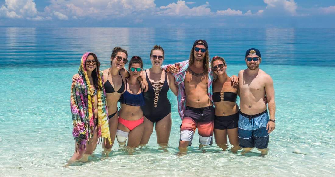 Travelers in the ocean in the Philippines A group of travelers standing in the ocean in the Philippines