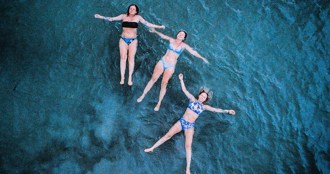 Girls in the ocean in Thailand Three girls floating in the ocean in Thailand