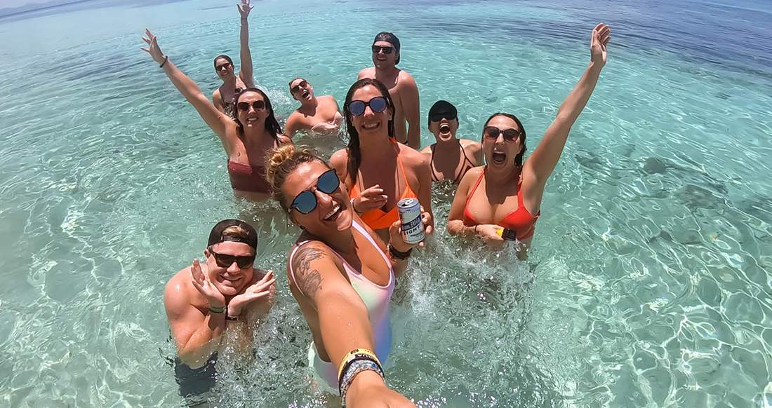 Travelers in the ocean in the Philippines A group of travelers take a selfie in the ocean in the Philippines
