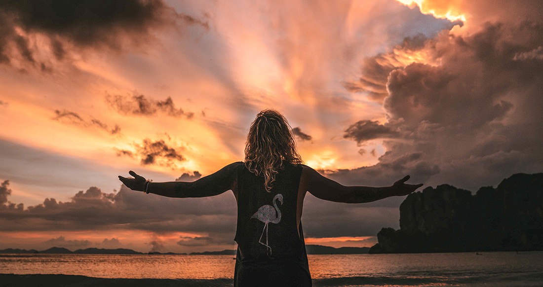 Railay beach Thailand sunset A man enjoying an epic sunset at Railay Beach in Thailand