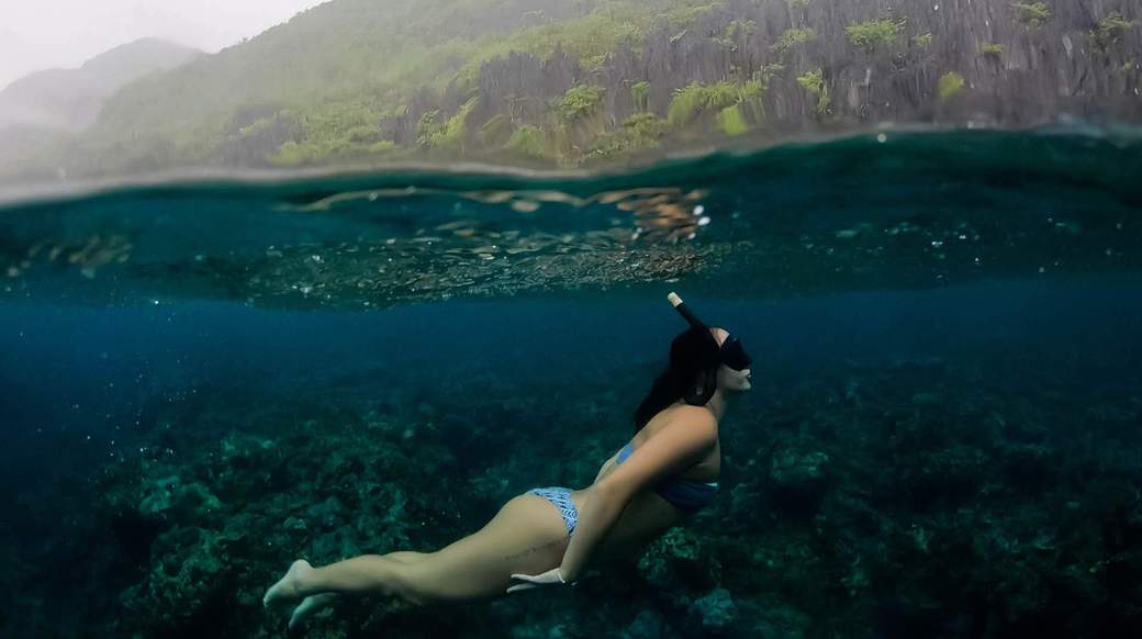 Snorkeling a girl snorkelling underwater in the Philippines