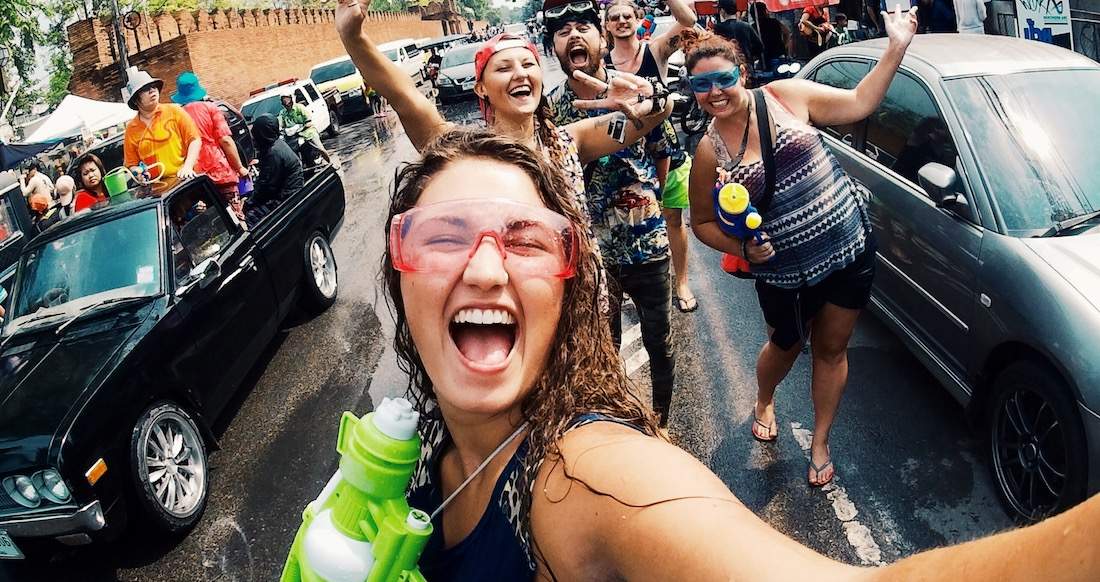 Songkran selfie group of travelers holding water guns and celebrating the Thai New Year