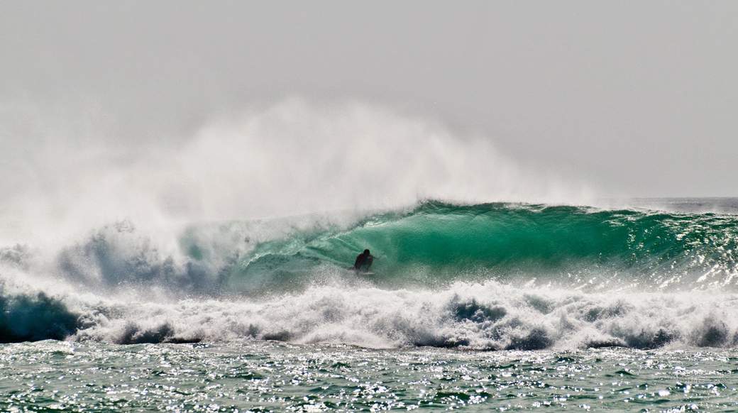 surfing A guy surfing in Indonesia on a big wave