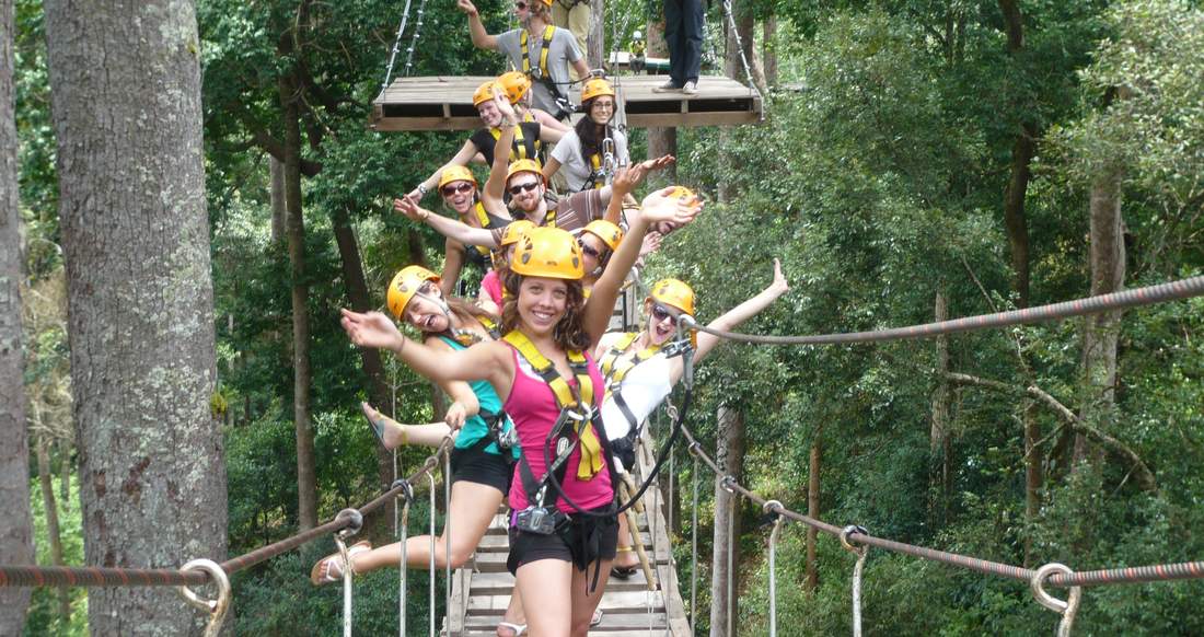 Travelers enjoying a tree top hike in Laos Group of travelers on a tree top hike in Laos