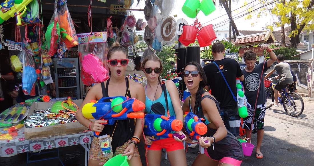 water guns and girls three girls holding super soakers getting ready for Songkran in Chiang Mai