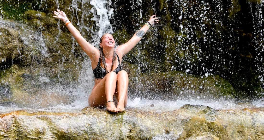Waterfall in northern Thailand Girl laughing in a waterfall in northern Thailand